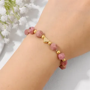 Elegant beaded bracelet featuring faceted pink stones and a polished gold heart charm gift