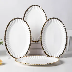 Set of 4 elegant white ceramic oval dinner plates with luxurious gold ruffled rim details
