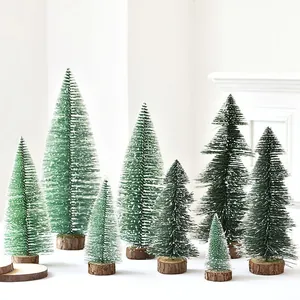 Group of mini snowy Christmas trees with natural wooden bases on white background