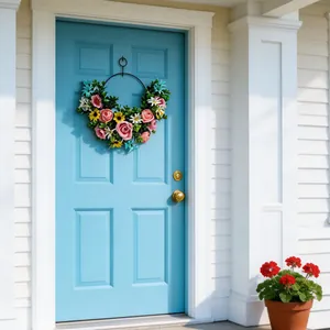 Vibrant artificial floral wreath hanging on a stylish sky blue front door for home decoration