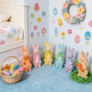 Set of colorful glitter Easter bunny ornaments with ribbons in a cozy home setting