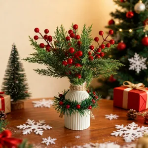 Festive Christmas table centerpiece with white ceramic vase, red berries, and cedar.