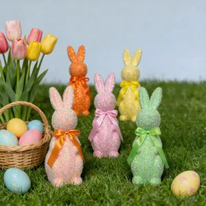 Detailed close-up view of colorful glitter Easter bunny ornaments with ribbons on grass