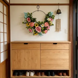 Elegant colorful artificial flower wreath hanging on wall as creative home decoration