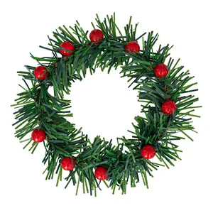 Mini Christmas wreath with green pine needles and red berries for DIY holiday decor.