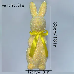 Detaillierte Größenangaben für gelbe Glitzer-Osterhasen-Deko mit einer gelben Schleife