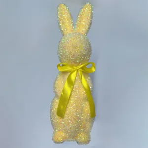 Close-up detail showing the shimmering yellow glitter and sequin texture of the Easter bunny.