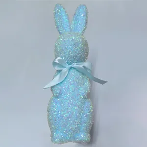 Detailed view of a sparkling blue glitter Easter bunny figurine with a satin ribbon.