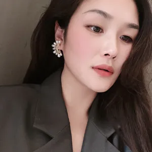 Elegant S925 silver needle semi-circle earrings with micro-paved pearls worn by a model