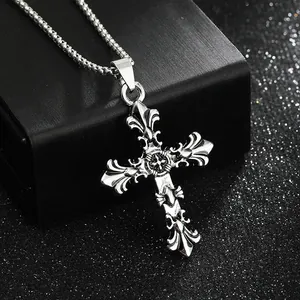 Macro detail of a retro silver gothic cross pendant on a textured jewelry box