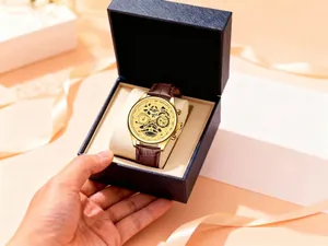Luxury gold men's quartz watch with brown leather strap inside a premium gift box.