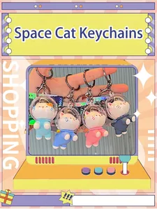 Close-up of four colorful space cat PVC keychains featuring transparent space helmets