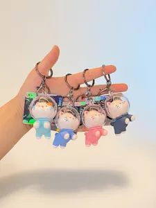 Close-up of four colorful space cat PVC keychains featuring transparent space helmets