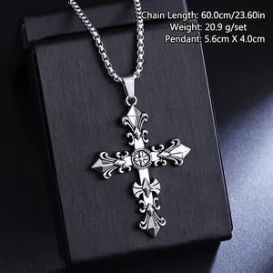 Detailed view of a vintage titanium steel cross pendant necklace on a black display box.