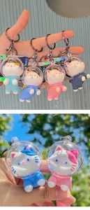 Close-up of cute astronaut cat PVC keychains in various colors for bag accessories