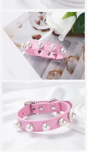 Close-up of pink PU leather pet collar featuring elegant white pearls and rivets