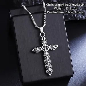 Macro view of vintage titanium steel cross pendant necklace with ornate engraved patterns