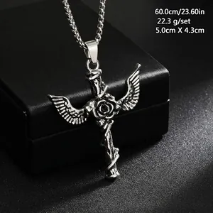 Detailed view of vintage titanium steel winged cross pendant necklace with rose engraving