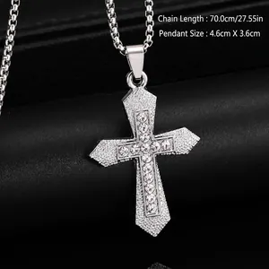 Macro detail of a silver-toned titanium steel cross pendant with inlaid rhinestones