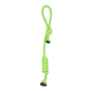 Detail of green and white braided cotton rope dog chew toy for dental cleaning.