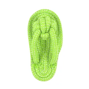 Close-up of green and white braided cotton rope dog chew toy in flip-flop sandal shape