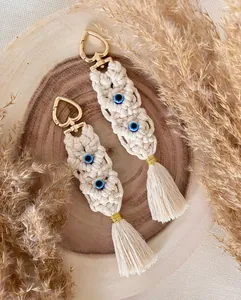 Detailed view of handmade boho macrame keychain with evil eye beads and gold heart clasp