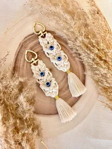 Detailed view of handmade bohemian macrame keychains with tassels and evil eye beads.