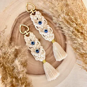 Handmade Bohemian macrame tassel keychain with evil eye beads and gold heart clasp ornament