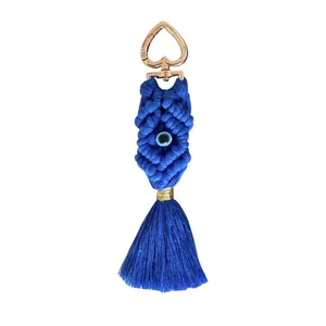 Handmade bohemian woven cotton keychain with blue tassel, evil eye bead, and heart clasp
