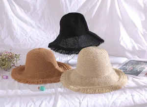 Detail shot of breathable straw bucket hats with stylish frayed edges in various colors