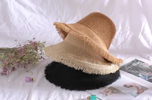 Stack of three breathable straw bucket hats with stylish frayed edges in various colors