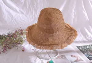 Detailed view of women's breathable straw bucket hat with a stylish frayed brim