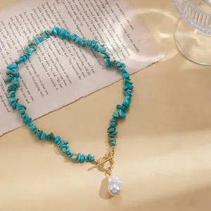 Detailed view of turquoise stone necklace with baroque pearl and OT clasp