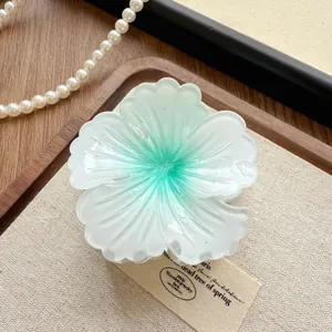 Detailed close-up view of the elegant gradient green and white flower hair claw clip