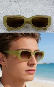 Model wearing retro small frame sunglasses with jelly green frames and tea lenses