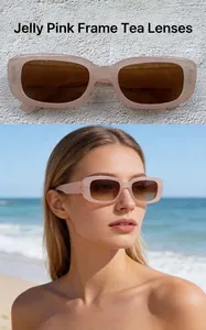 Retro rectangular sunglasses with jelly pink frames and tea lenses worn by model.