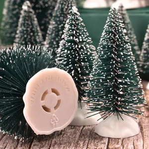 Mini flocked pine needle Christmas trees with white snow tips and stable plastic base