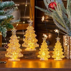 Detail showing four glowing crystal-like mini Christmas trees in warm yellow light
