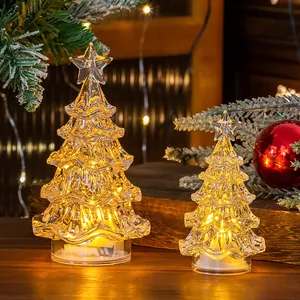 Close-up detail of warm LED light glowing inside crystal-style mini Christmas trees