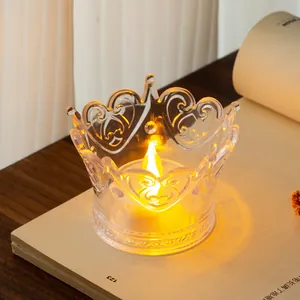 Close-up of crown-shaped transparent LED tea light with a warm yellow glow