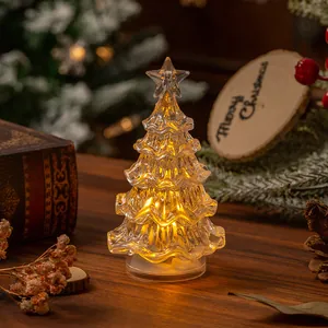 Detailed view of mini glowing crystal Christmas tree with warm LED lights for desk decoration
