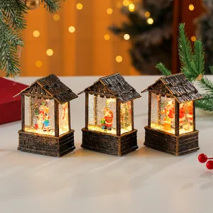 Set of three decorative glowing Christmas house lanterns with internal snow globe effect