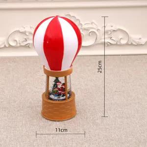 Detailed view of musical Christmas hot air balloon snow globe showing 25cm height