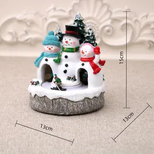 Detailed macro view of resin Christmas music box showing 15cm x 13cm product dimensions.