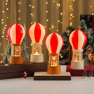 Detailed close-up view of festive Christmas hot air balloon snow globes with music and lights