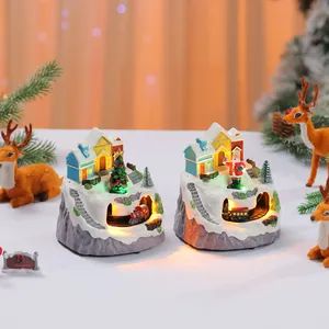 Detailed view of two light-up musical Christmas house ornaments with rotating trains