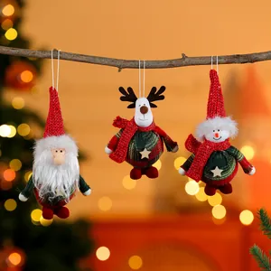 Set of three festive Christmas fabric ornaments hanging on a rustic wooden branch