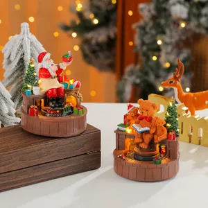 Macro view of rotating glowing Christmas music box with Santa and teddy bear figures