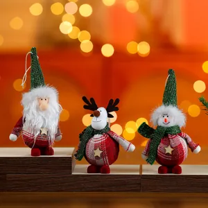 Macro detail view of three cute standing Christmas fabric ornaments on wooden display steps