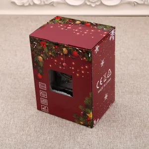 Detailed festive red Christmas packaging box for musical glowing snow house ornament